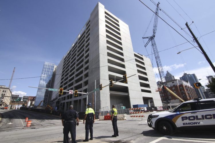 Emergency personnel respond to the parking garage that partially collapsed on Saturday.  The parking deck under construction has collapsed for a second time in as many days.