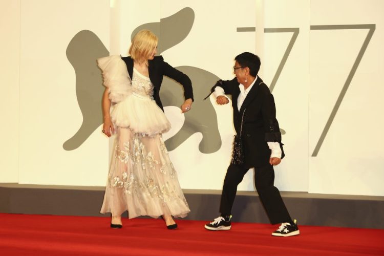Director Ann Hui, right, and Jury President Cate Blanchett greet one another by touching elbows upon arrival at the red carpet for the Lifetime Achievement award for Ann Hui during the 77th edition of the Venice Film Festival in Venice, Italy, on Tuesday. 