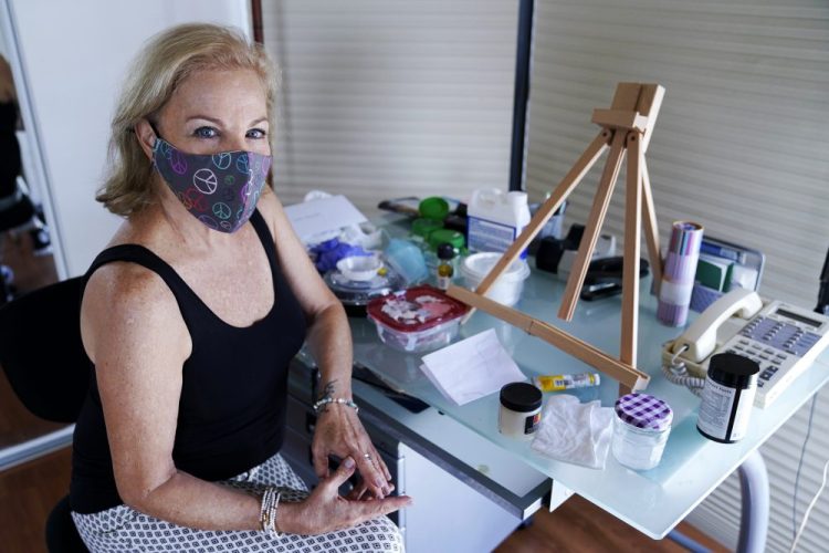 Artist Irene Pressner, a Venezuelan artist and a COVID-19 survivor who lost her husband to the virus, is creating new works inspired by her experience, in Aventura, Fla. 