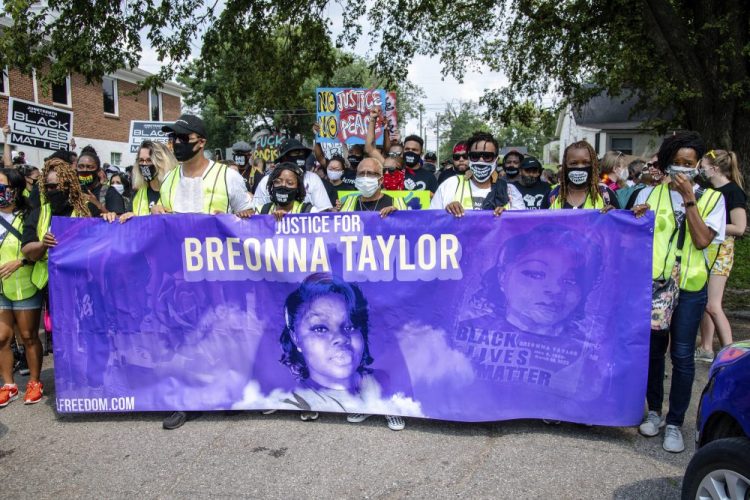 Protesters participate in the Good Trouble Tuesday march for Breonna Taylor on Aug. 25, in Louisville, Ky. A lawyer for Taylor's family said a plea deal was offered to an accused drug trafficker that would have forced him to implicate Taylor, who was killed by police in a raid on her home in March. 