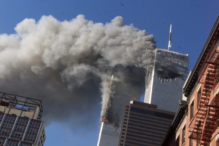 Smoke rises from the burning twin towers of the World Trade Center after hijacked planes crashed into the towers, in New York City on Sept. 11, 2001. 

