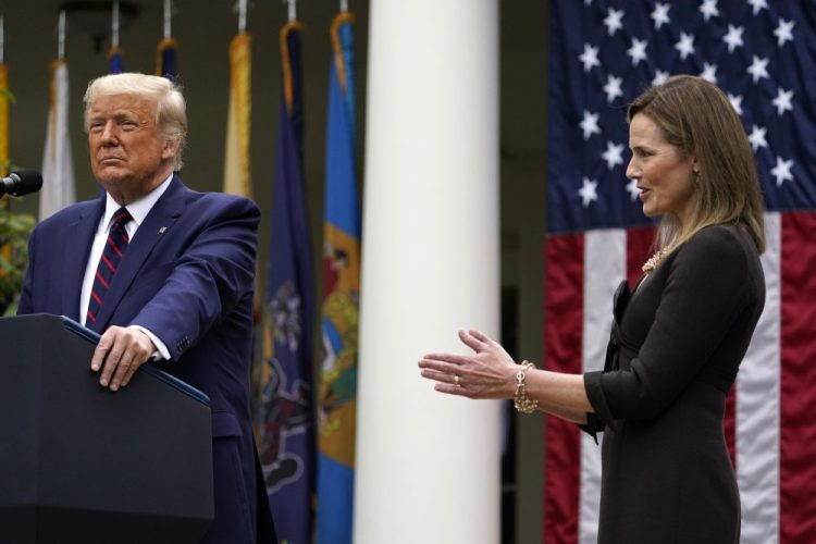 Judge Amy Coney Barrett applauds as President Trump announces Barrett as his nominee to the Supreme Court, in the Rose Garden at the White House on Saturday. 