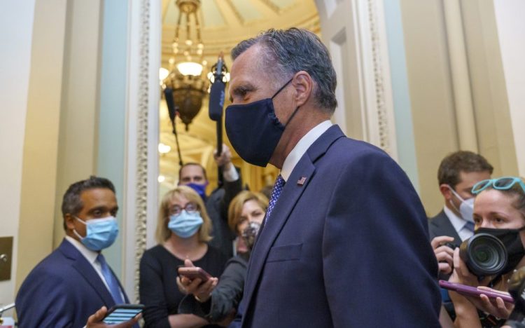 Sen. Mitt Romney, R-Utah, leaves the Senate chamber after a vote Monday. Romney said Tuesday that he supports a vote on a replacement for the late Justice Ruth Bader Ginsburg before Election Day.