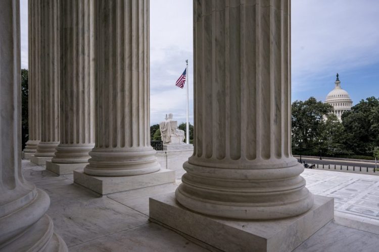The columns of the Supreme Court are seen June 15 with the Capitol at right, in Washington.