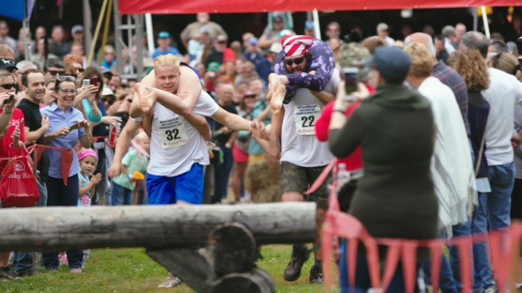 Actors representing teams from Finland and the U.S. in a scene from the mocumentary "Couples of Wife Carrying" filmed at Sunday River and Bethel. 