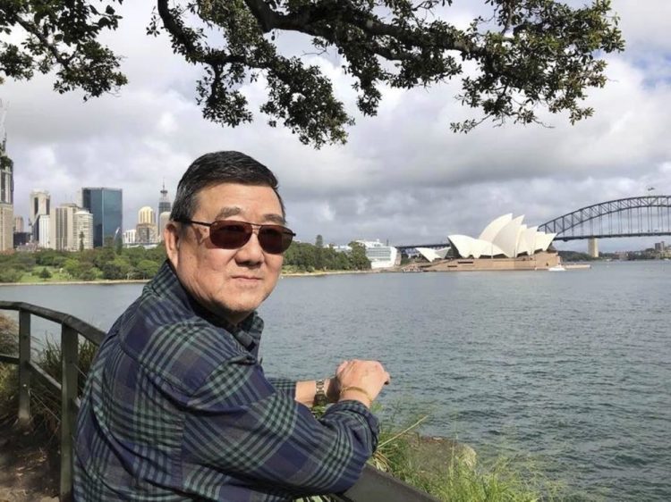 Ming Wang in Sydney, Australia, in March. The 71-year-old was sickened in March on a cruise from Australia with his wife, a break after decades of running the family’s Chinese restaurant in Papillion, Neb.
