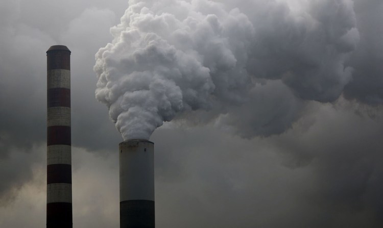 Water vapor rises from a fossil plant. Bloomberg photo by Luke Sharrett