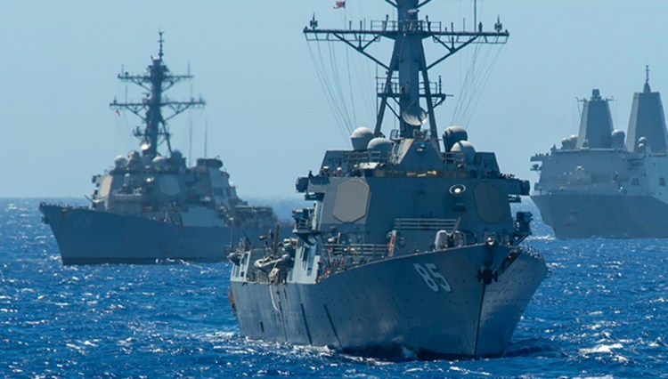 Two Arleigh Burke-class guided-missile destroyers, the USS McCampbell and the USS Milius (DDG 69) accompanied by the amphibious transport dock ship USS Green Bay in the Philippine Sea in 2019.