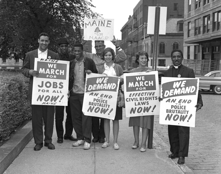 In August 1963, Gerald Talbot stands at left on Market Street with other Mainers who took part in the March on Washington. Left to right: Gerald Talbot, Alfred Burris, Lawrence Graham, Reverend Valton V. Morse, Elizabeth Aldrich, Mrs. Joseph Robey, Reverend John C. Bruce