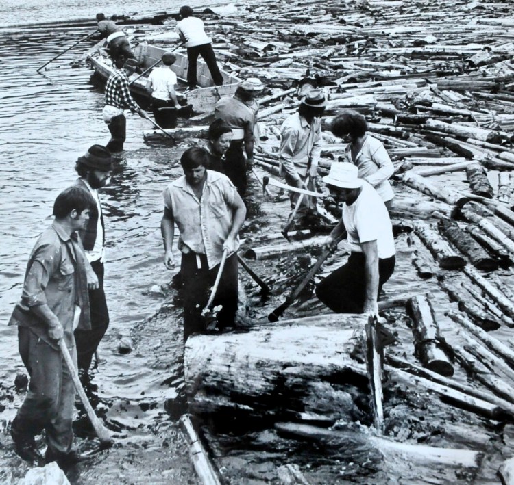 Log drive workers including David Calder of Canaan prepare to move floating logs piled up near The Great Eddy on the Kennebec River in Skowhegan in the 1970s.  
