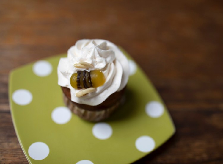 Banana Cupcake with Honeyed Buttercream Topping. Don't forget the cute garnish: a Jujyfruit honeybee.