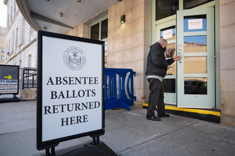PORTLAND, ME - OCTOBER 2: A man enters the lobby area of Merrill Auditorium in Portland to drop off his absentee ballot on Monday. It was the first day of absentee voting and ballot collection in Portland. (Staff Photo by Gregory Rec/Staff Photographer)