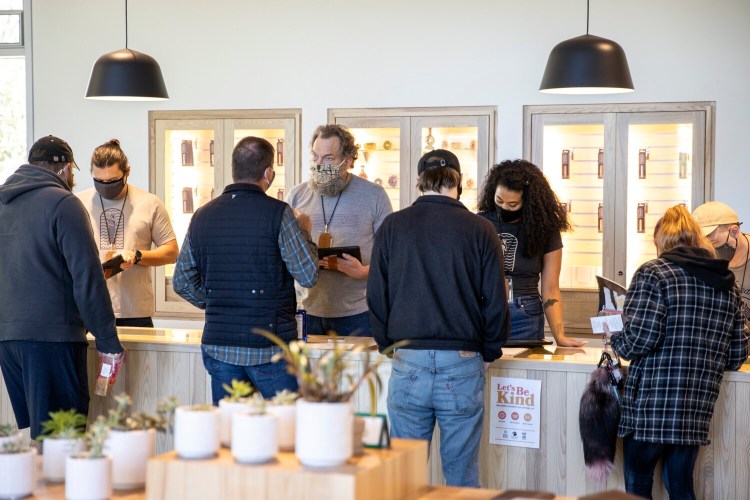 Budtenders help customers at SeaWeed Co. in South Portland  on the first day of recreational marijuana sales in October. Records show 21,194 sales made at six recreational marijuana stores licensed to do business in their first month of business.