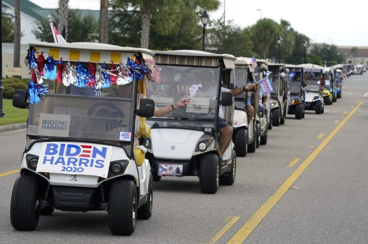 A parade of over 300 supporters of Democratic presidential candidate former Vice President Joe Biden caravanned to the Sumter County Elections office to cast their ballots during early voting Wednesday in The Villages, Fla. 
