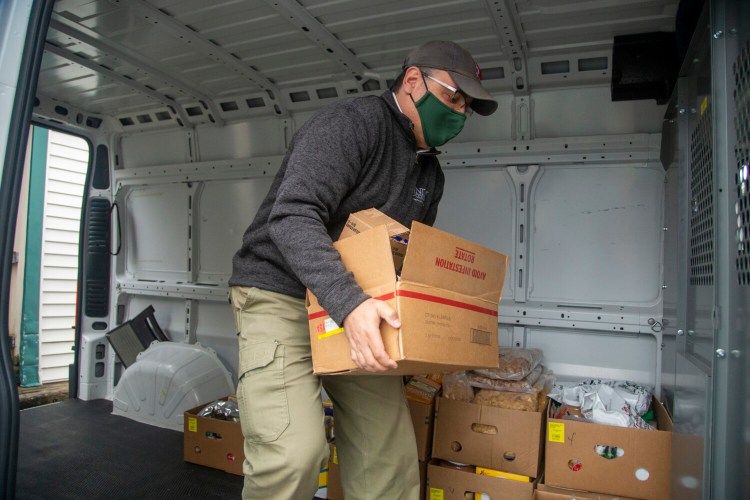 Dr. Melik Peter Khoury, president of Unity College, helps load food into the Waterville Food Bank’s van on Oct. 21. The college donated 1,141 individual items and roughly 1,851 pounds.
