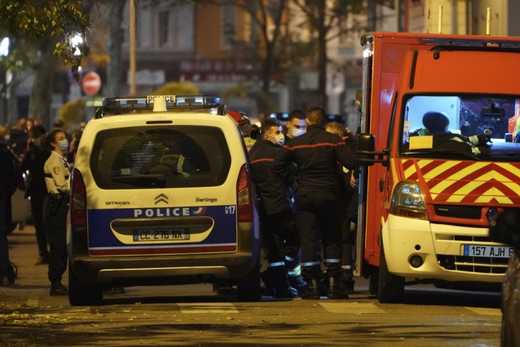 Police officers and rescue workers block access to the scene after a Greek Orthodox priest was shot Saturday while he was closing his church in the city of Lyon, central France. The priest, a Greek citizen, is in a local hospital with life-threatening injuries after being hit in the abdomen, a police official said. 