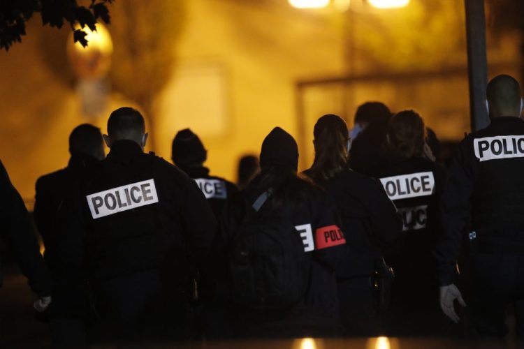 French police officers gather outside a high school after a history teacher who opened a discussion with students on caricatures of Islam's prophet Muhammad was beheaded Friday  in Conflans-Saint-Honorine, north of Paris. Police fataly shot the suspected killer.

