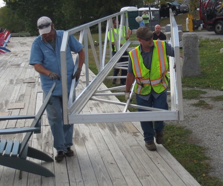 Hallowell Public Works Director Chris Buck, left, and Todd Tallon move the new bulkhead ramp into place with help from Tom Gorta, back left, and Hammond Lumber’s Ryan Masse in the rear.