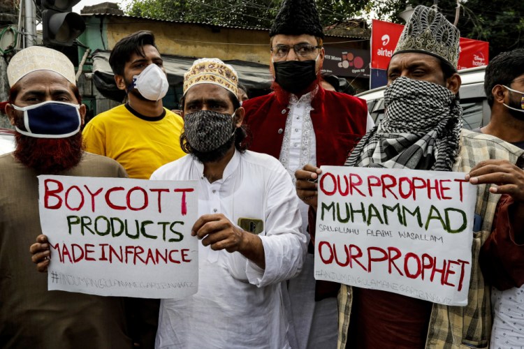 Muslim activists protest against France, near the French Consulate, in Kolkata, India, on Saturday. Muslims have been calling for both protests and a boycott of French goods in response to France's stance on caricatures of Islam's most revered prophet.

