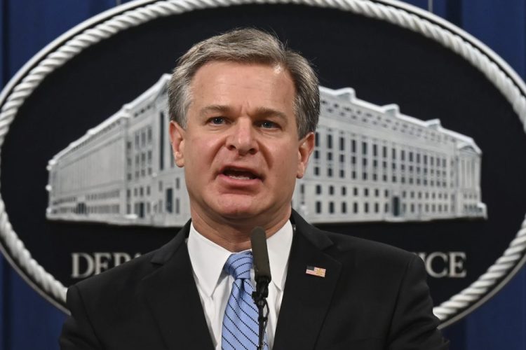 FBI Director Christopher Wray, shown in October, was among more than a dozen people whose images, home addresses and other personal information were posted on a website, Enemies of the People. 
