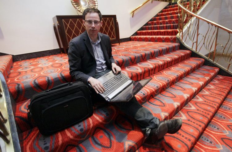 Nate Silver, statistician, unabashed numbers geek, author and creator of the much-read FiveThirtyEight, sits on the stairs at Allegro hotel in downtown Chicago. 