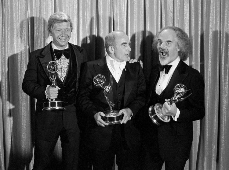 Screenwriter William Blinn, left, Ed Asner, center, and David Greene pose with their Emmy statuettes at the annual Primetime Emmy Awards presentation Sept. 11, 1977, in Los Angeles.