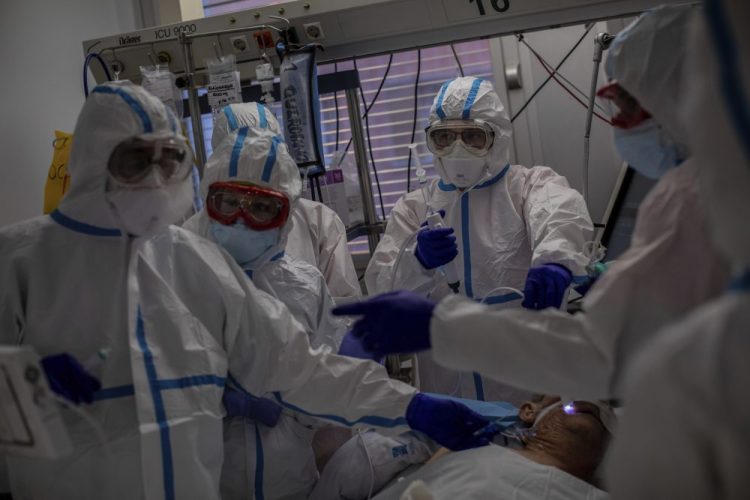 A medical team treats a patient infected with COVID-19 in one of the intensive care units Friday at the Severo Ochoa hospital in Leganes, outskirts of Madrid, Spain. 

