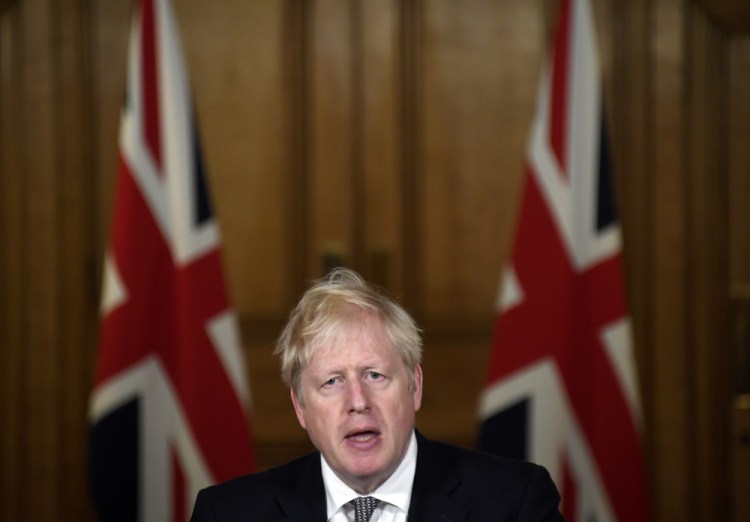 Britain's Prime Minister Boris Johnson speaks during a press conference in 10 Downing Street, London, on Saturday, where he announced new restrictions to help combat a coronavirus surge.