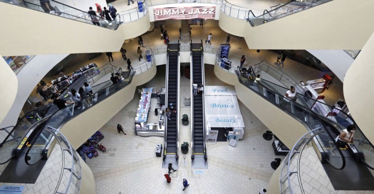 Shoppers walk through the Queens Center shopping mall in the Queens borough of New York on Sept. 9.