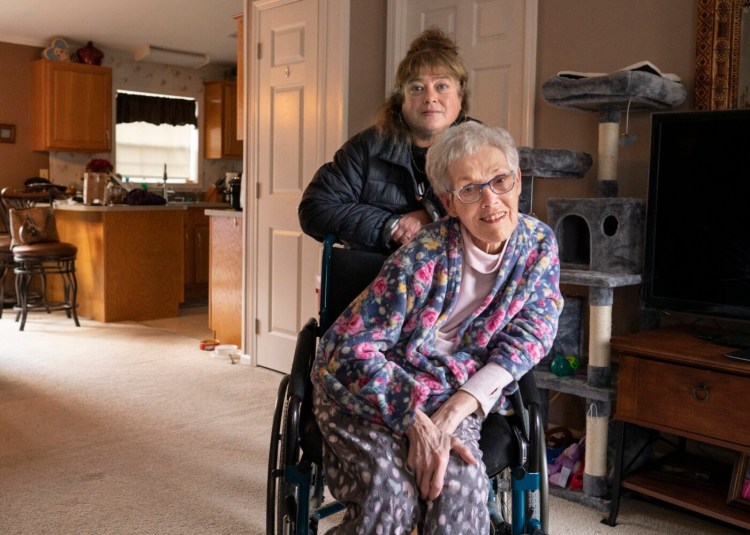 Tonya Joy poses with her mother Maureen, who has multiple sclerosis, in Maureen's Gorham home on Monday. Joy, a former bartender at Linda Bean's Maine Lobster Café at the Portland International Jetport, has filed a lawsuit against the jetport's foodservice management company, HMS Host Corp.