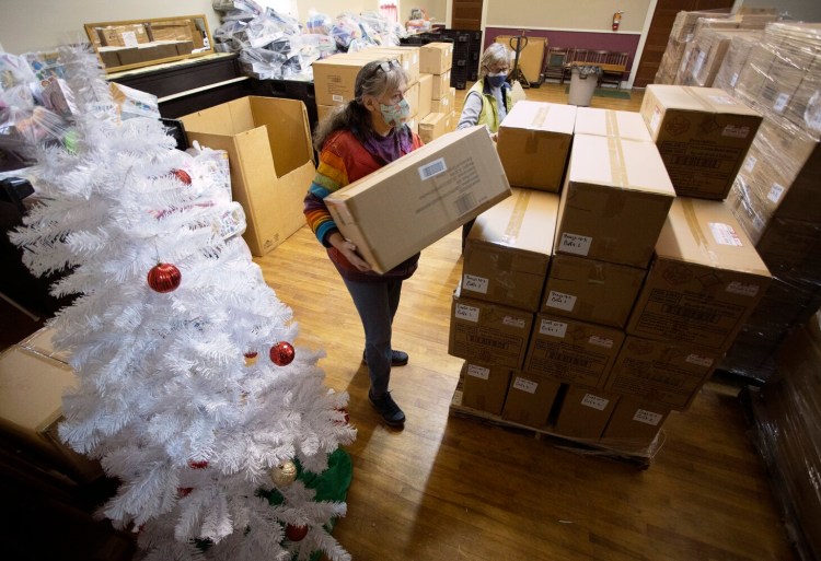 Kathleen Meade, left, and Julie Pew organize boxes of toys for The Portland Press Herald Toy Fund this month.