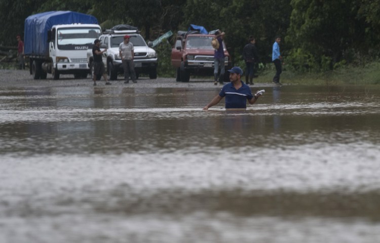 A man walks through a flooded road in Okonwas, Nicaragua, on Nov. 4. 
