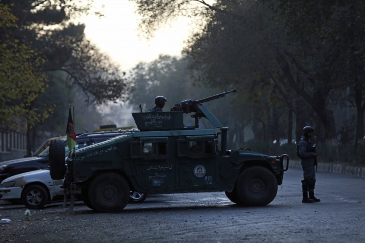 Afghan police patrol the site of an attack at Kabul University in Kabul, Afghanistan, on Monday.  The assault sparked a hours-long gun battle. 
