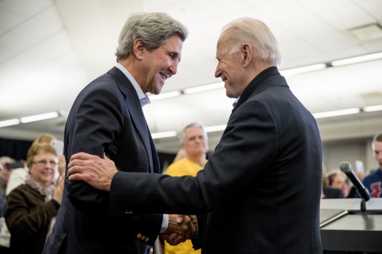 Democratic presidential candidate former Vice President Joe Biden smiles as former Secretary of State John Kerry, left, takes the podium to speak at a campaign stop Feb. 1 at the South Slope Community Center in North Liberty, Iowa. 

