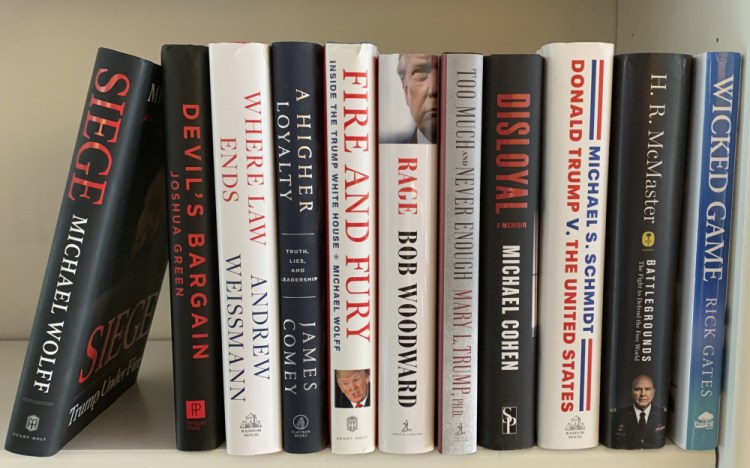A collection of books about President Donald Trump, from left, "Siege" by Michael Wolff, "Devil's Bargain" by Joshua Green, "Where Law Ends" by Andrew Weissmann, "A Higher Loyalty: Truth, Lies, and Leadership" by James Comey, "Fire and Fury: Inside the Trump White House" by Michael Wolff, "Rage" by Bob Woodward, "Too Much and Never Enough" by Mary L. Trump, "Disloyal" by Michael Cohen, "Donald Trump V. The United States" by Michael S. Schmidt, "Battlegrounds: The Fight to Defend the Free World" by H. R. McMaster and "Wicked Game" by Rick Gates. 