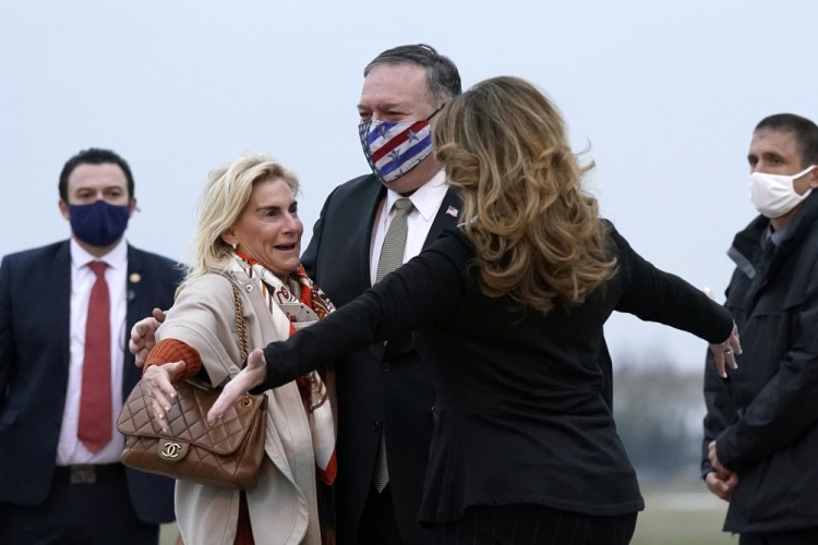 U.S. Secretary of State Mike Pompeo, center, and his wife, Susan, right, embrace U.S. Ambassador to France Jamie McCourt, left, after stepping off a plane at Paris Le Bourget Airport on Saturday in Le Bourget, France. 