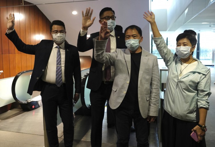 Pro-democracy legislators, from right, Wong Pik Wan, Wu Chi Wai, Lam Cheuk-ting and Yoon Siu Kin, wave after handing in their  letters of resignation at the Legislative Council in Hong Kong on Thursday.