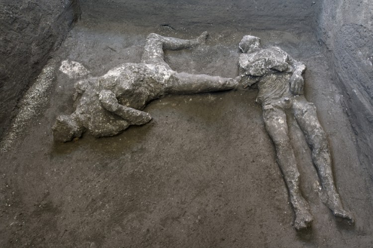 The casts of what are believed to have been a rich man and his male slave fleeing the volcanic eruption of Vesuvius nearly 2,000 years ago, are seen in what was an elegant villa on the outskirts of the ancient Roman city of Pompeii destroyed by the eruption in 79 A.D., where they were discovered during recent excavations, Pompeii archaeological park officials said Saturday,. 

