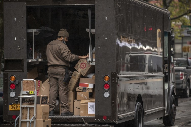 A United Parcel Service Inc. driver sorts boxes in New York on Oct. 13, 2020. MUST CREDIT: Bloomberg photo by Victor J. Blue.