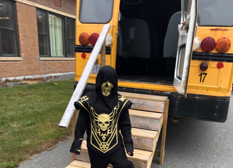 An unidentified Carrabec Community School students made is way through the haunted school bus.