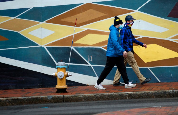 Pedestrians walk on Free Street in Portland on Friday, Nov. 27. 