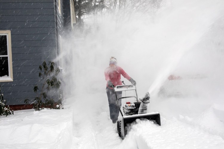 Liana Lemke clears her driveway in Portland at the tail end of the powerful winter storm that hit the Northeast on Thursday.