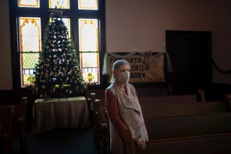 Marilyn Davis at Bowdoinham Nazarene Church with the Memory Tree on Wednesday. Davis came up with the idea for a Christmas tree with ornaments honoring all of the Mainers who have died from COVID-19. 