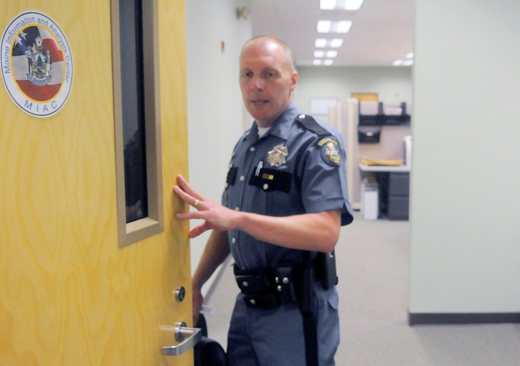 Lt. Scott Ireland opens a door to the Maine Information and Analysis Center at the Department of Public Safety in Augusta in 2016.