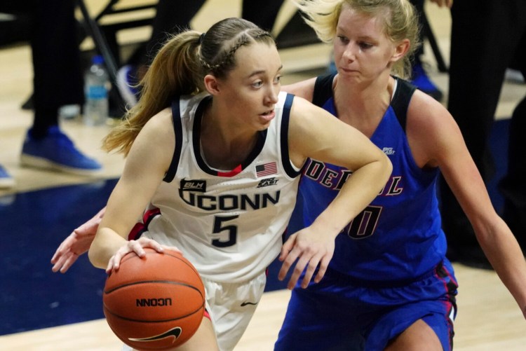 Connecticut guard Paige Bueckers (5) drives against DePaul guard Lexi Held (10) in the first half of an NCAA college basketball game Tuesday, Dec. 29, 2020, in Storrs, Conn. (David Butler II/Pool Photo via AP)