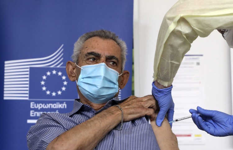 Andreas Raounas, 84, was the first patient at a care home in Nicosia, Cyprus, on Sunday to get the vaccine. 