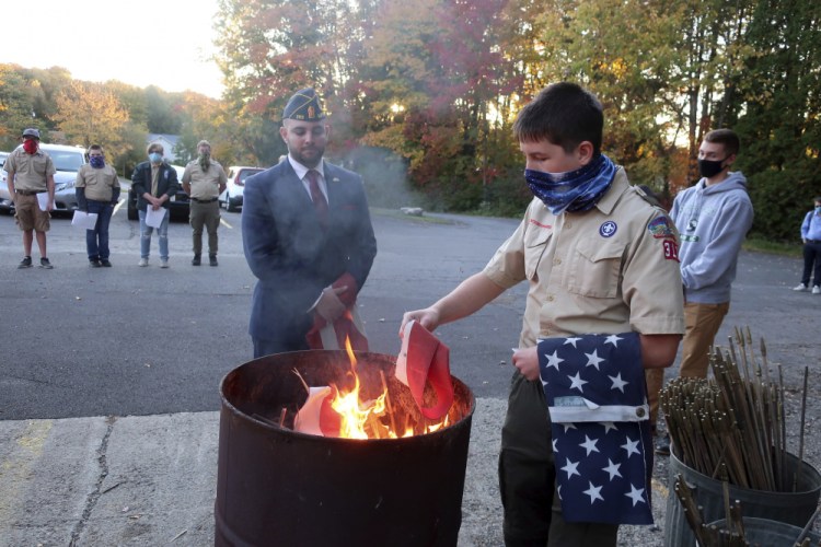 Jondavid Longo, Republican mayor of Slippery Rock, Pa., center, presides over a Boy Scouts flag retirement ceremony where worn out flags are cut up and burned Oct. 13 in Slippery Rock.
