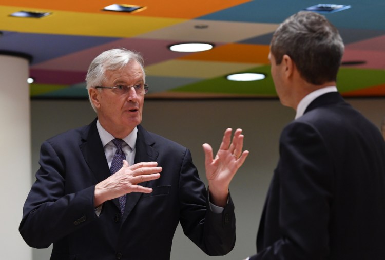 European Union's chief Brexit negotiator, Michel Barnier, left, speaks with Ambassador Michael Clauss, Permanent Representative of Germany to the European Union, during a meeting of EU ambassadors in Brussels on Tuesday. Problems increased Monday in the bid to put a trade deal between the European Union and the United Kingdom before a Brexit transition period ends on New Year's Day, with the EU legislature insisting it will not have time to approve a deal. (John Thys, Pool via AP)
