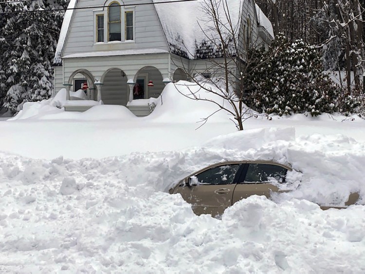 This photo, provided by the New York State Police, shows a car, in Owego, NY, from which a New York State Police sergeant rescued Kevin Kresen, 58, of Candor, NY, stranded for 10 hours, covered by nearly 4 feet of snow thrown by a plow during this week's storm.  