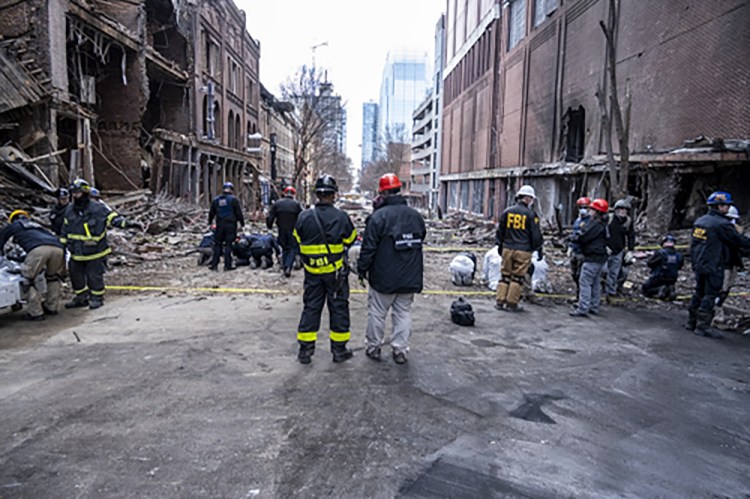 In this photo provided by the FBI and Bureau of Alcohol, Tobacco, Firearms and Explosives, FBI and ATF Evidence Response Teams process the scene, Monday, Dec. 28, of the Christmas Day blast in Nashville, Tenn. 